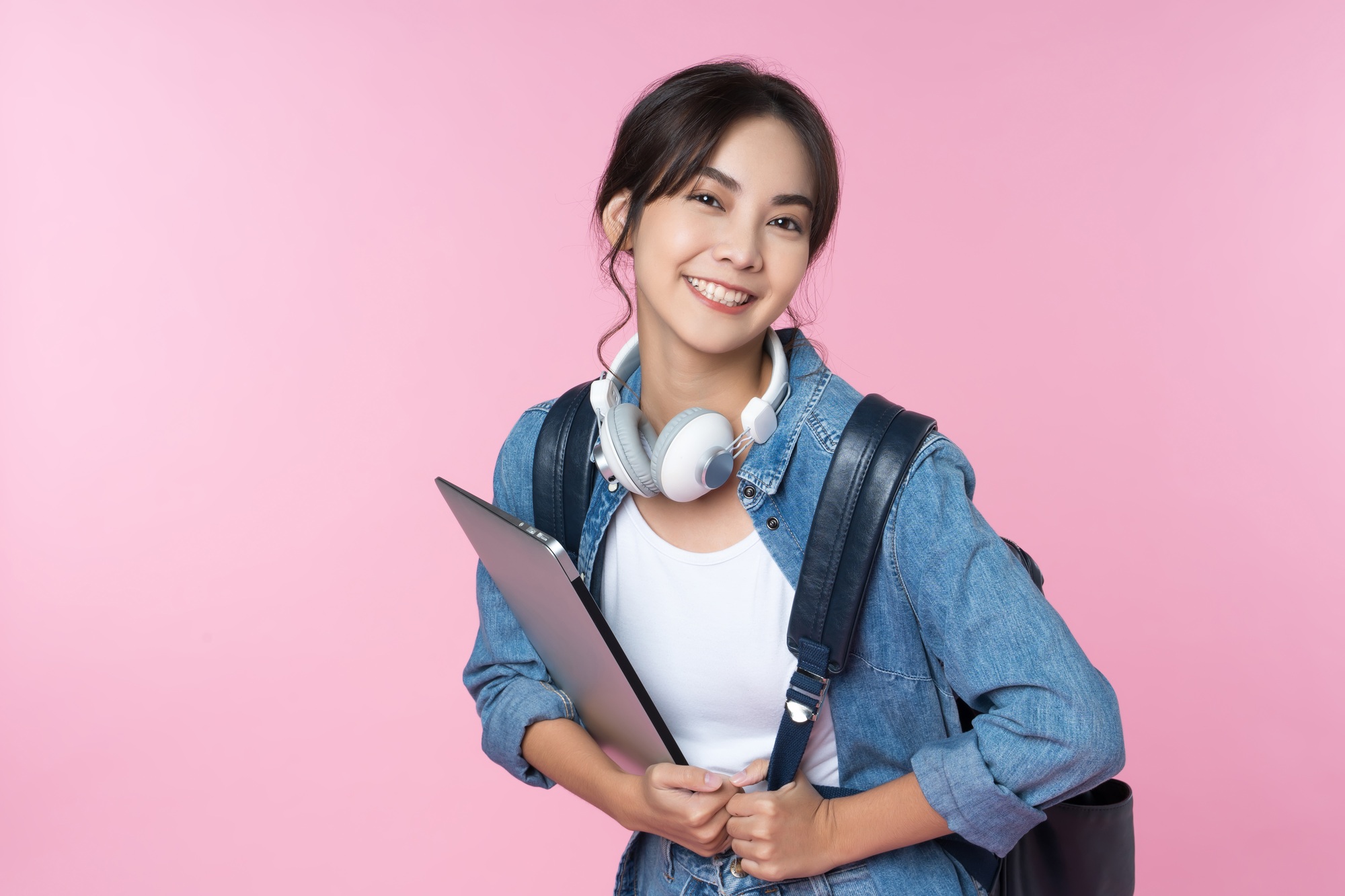 Portrait of young Asian woman student with smartphone coffee and backpack.College Teenager